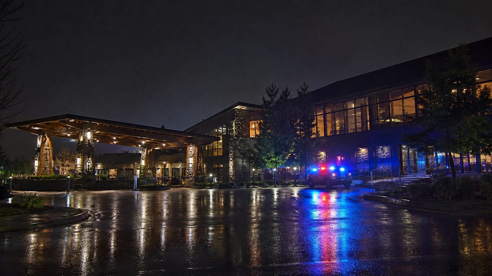 Quiet Oregon tribal casino exterior with restrained emergency lights